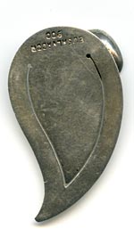 This bookmark was made in El Salvador. It is marked 900 and El Salvador. It is in the shape of a coffee leaf with a coffee bean and another leaf on top.