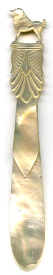 This bookmark was made in France. It is a French Palais Royal mother-of-pearl hand carved figural dog sitting up on a pedestal. The date is 1880 - 1900.
