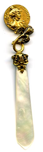 This bookmark was probably produced in France. It is made of mother-of-pearl and gold plate over pot metal. It has two sided coin of women heads held up by an iris flower. The blades are light and dark MOP. The date is 1880 - 1900.