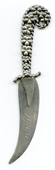 This bookmark was made in the US by an unknown manufacturer. Marked only sterling on the back, it is in the shape of a knife with a rope and flower handle.