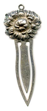 This bookmark was made in the US by an unknown maker  but it closely resembles those of Unger Bros. The top is a flower and has a loop for a tassel. 