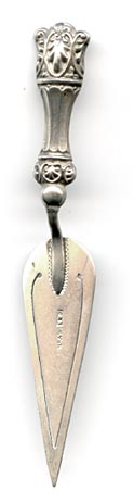 This bookmark was made in England by Chrisford and Norris. It is marked C&N Silver on the middle blade. The overall shape is that of a trowel with a fancy handle.