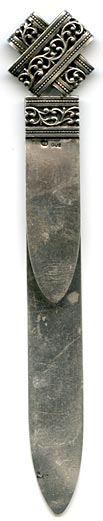 This bookmark was made in Europe. The top looks like two loops of silver filigree crossed and flattened. The same band can be seen at the top of the two blades underneath the loops. It is marked HB 800. 