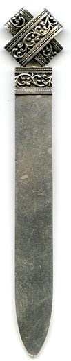 This bookmark was made in Europe. The top looks like two loops of silver filigree crossed and flattened. The same band can be seen at the top of the two blades underneath the loops. It is marked HB 800. 