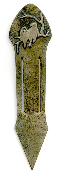 This bookmark was made in the US by the Heintz Art Metal Shop. It is unmarked. The top is a pair of sterling birds on a branch. The bookmark is bronze with a florentine silver finish. The date is 1910 - 1920.