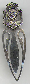 This bookmark is American made sometime before 1921. The manufacturer is Rogers, Lunt & Bowlen Co. It is marked with the catalog number 172, Sterling and a hallmark. The top of the bookmark depicts the state seal of Illinois.