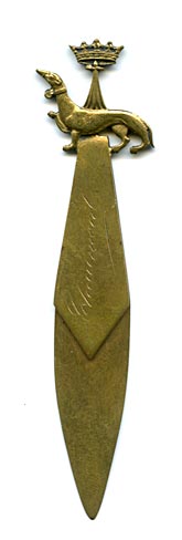 This bookmark was made in France. It is brass, has Chaumont inscribed on the top blade and has a dog and crown on the top.