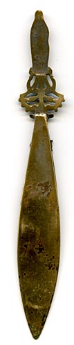 This bookmark was made in France as a souvenir for Our Lady of Lourdes, depicted as the finial on the top. It is brass with warn silver plating. The Lourdes shield is highlighted above.