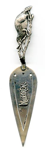 This bookmark was made in Canada or the US by an unknown manufacturer. It is in the shape of a trowel with the handle in the shape of a beaver on a tree branch. The middle blade says Montreal. It is marked sterling on the back.