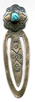 This is an older signed silver book mark with tamp work and blue turquoise stone in a serrated bezel. Marked on the back JCJ and STERLING, made by Isleta Pueblo silversmith Joann Christine Juancho.