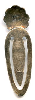 This is an older signed silver book mark with tamp work and blue turquoise stone in a serrated bezel. Marked on the back JCJ and STERLING, made by Isleta Pueblo silversmith Joann Christine Juancho.