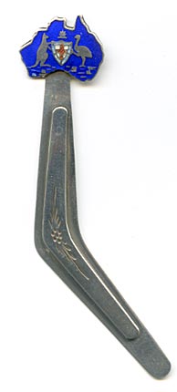 This bookmark is shaped like a boomerang with an enamel figural of Australia on the top. Within the figure is a kangaroo and an emu holding a shield. The back is marked stg silver with a unicorn mark.