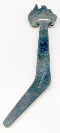 This bookmark is shaped like a boomerang with an enamel figural of Australia on the top. Within the figure is a kangaroo and an emu holding a shield. The back is marked stg silver with a unicorn mark.