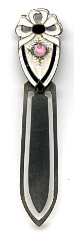 This bookmark was made in the US by F.A. Hermann Co. It is barely marked sterling but is the same as others in this collection. The top is an enamel shield with a bow above and a pink flower in the center.