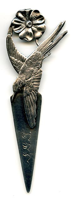 This bookmark was made in the US by Gorham Mfg. Company. It is marked with the manufacturers mark, sterling and 48, the number from the catalogue. This particular bookmarks has the rooster date mark indicating 1890. The top has a highly detailed hummingbird and flower with the wing of the bird forming the top blade. 