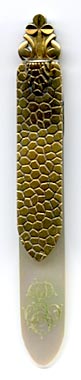 This bookmark was made in France by Jules Herice. It is marked on the top blade and on the back of the top blade with the initials JH.  The top blade looks to be either gold or brass. The bottom blade is mother of pearl. The very top has a clover.