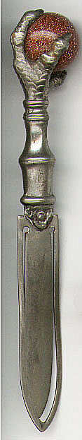 This bookmark is not silver but of some unknown metal. It has a starstone sphere held by four claws. It is an art nouveau piece made between 1900 - 1920 probably in the United States.