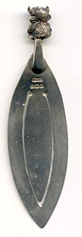 This bookmark was made in Birmingham England by an unknown manufacturer with the hallmark of T&JB. It has the date mark of g indicating 1906. The top is a figural Lincolnshire Imp, seen in the Angel Choir at Lincoln Cathedral.