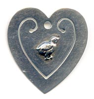 This bookmark was made in the US by an unknown manufacturer. It is marked sterling on the back. It is in the shape of a heart with a baby chick in the center of the  inside blade.