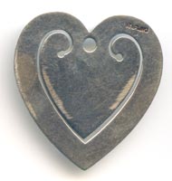 This bookmark was made in the US by an unknown manufacturer. It is marked sterling on the back. It is in the shape of a heart with a baby chick in the center of the  inside blade.