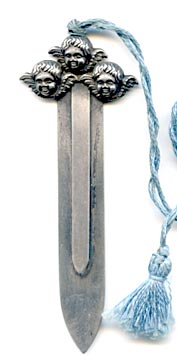 This bookmark was made in the US by an unknown manufacturer. The top has three cherub faces it high relief and has a 10.5 inch tassel. 