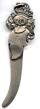 This bookmark was made in the US by an unknown manufacturer. The top blade, in the shape of a leaf is inscribed LPW. The very top has leaves and a crown.