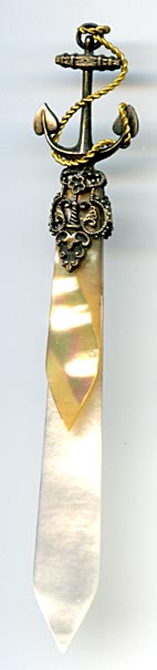 This bookmark was probably produced in France. It is made of mother-of-pearl and brass plate over pot metal. It has a very detailed anchor wrapped in a gold rope. The blades are light and dark MOP. The date is 1880 - 1900.
