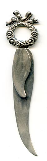 This bookmark was made in the US by La Pierre. It has the manufacturers hallmark, sterling and the number 449. The top has a wreath of flowers with a ribbon on top.