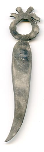 This bookmark was made in the US by La Pierre. It has the manufacturers hallmark, sterling and the number 449. The top has a wreath of flowers with a ribbon on top.