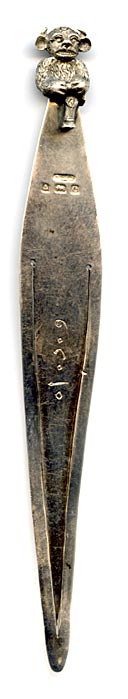 This bookmark was made in Birmingham England by an unknown manufacturer with the hallmark of B.H.J. It has the date mark of e indicating 1904. The top is a figural Lincolnshire Imp, seen in the Angel Choir at Lincoln Cathedral.
