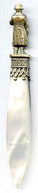 This bookmark was made in France as a souvenir of the Musee de L'Armee. It is silver plated brass, abalone and mother-of-pearl. The top has a statue of Napoleon. Underneath there is an eagle. The Musee de L'Armee, located at the Invalides in Paris, France was originally built as a hotel for disabled soldiers (Invalides) by Louis XIV and now houses the Tomb of Napoleon 1st and the museum of the Army of France.