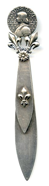 This bookmark was made in France. The top has a medallion with the head of Joan D'Arc. It is held up by two fleur-de-lis'. The top blade also has a fleur-de-lis.