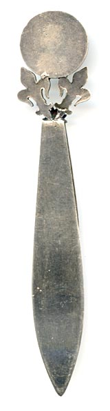 This bookmark was made in France. The top has a medallion with the head of Joan D'Arc. It is held up by two fleur-de-lis'. The top blade also has a fleur-de-lis.