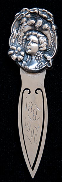 This bookmark is made in the US by an unknown manufacturer. It is marked Sterling Front and has a victorian lady head on the top