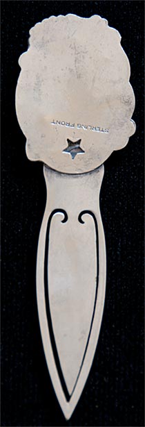 This bookmark is made in the US by an unknown manufacturer. It is marked Sterling Front and has a victorian lady head on the top