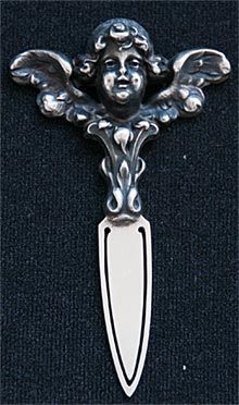 This bookmark is a William B. Kerr & Co. piece but it is unmarked. It has a large cherub with outstretched wings.