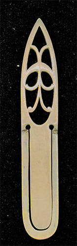 This is an American made bookmark. The manufacturer is Gorham. It is marked with the manufacturers hallmark, Sterling and the catalog number B3128. The top is an art nouveau cutout design. The date is 1900 - 1920.