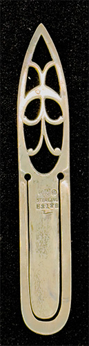 This is an American made bookmark. The manufacturer is Gorham. It is marked with the manufacturers hallmark, Sterling and the catalog number B3128. The top is an art nouveau cutout design. The date is 1900 - 1920.