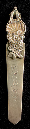 This bookmark was made in the US by Gorham Mfg. Company. It is marked with the manufacturers mark, sterling 30 and a star (indicating 1871). 30 is the number from the Autumn 1888 catalogue.