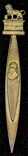 This bookmark was made in France by an unknown manufacturer. It is unmarked and is made of brass. The top is a figural lion and the top blade has a bust of Napoleon. Under the lion it is inscribed XVIII JUNI MDCCCCXV, the date the Battle of Waterloo started