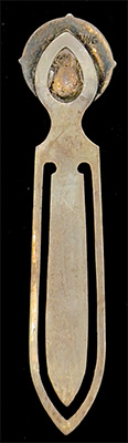 This bookmark was made in the US by F.A. Hermann Co. It is hallmarked sterling on the back. The top is an enamel shield with a red star and horns?. This is possibly a university emblem. The date is 1900 - 1910.