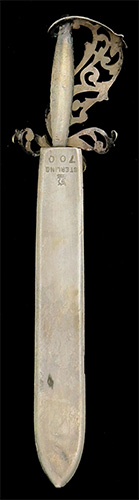 This bookmark was made in the US by H.H. Curtis, Inc. It is marked with the manufacturers hallmark, sterling and the number 700. The back in inscribed "Philopena". It is in the shape of a sword with a blue enamel grip and a fancy flowery hilt. The bottom blade is engraved Eleanor. The date is 1890 - 1910.