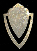 This bookmark was made in the US by F. A. Herman. It is marked with a hallmark of a triangle enclosing the letter H and sterling. The top is a cyan and black enamel shield. The date is 1900 - 1910.