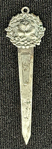 This bookmark was made in the US by an unknown manufacturer. It is marked sterling on the back. The top is a a rose surrounded by a wreath.