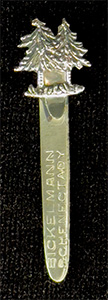 This bookmark was made in the US by an unknown manufacturer. The top is a figural of two trees. The blade says Bickelmann Schenectady.