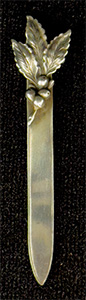 This bookmark was made in the US by Unger Bros. It is marked with the makers hallmark and Sterling 925 Fine. It a leaf design on top. This bookmark was sold from the 1904 Unger Bros. catalog.