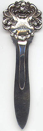 This bookmark was manufactured in the US by Gorham. It has a cherub on the top. It is marked with the Gorham hallmark, Sterling, B1471M and the year hallmark for 1898.