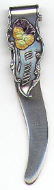 This bookmark was manufactured in the US by an unknown manufacturer. Marked only Sterling, it is enscribed July 12th on the back. It is has some enameled pansies with the french words 'a moi'". Date is probably from 1900 - 1920."