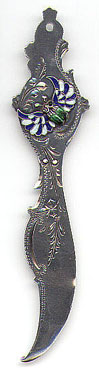 This bookmark was manufactured in the US by an unknown manufacturer. Marked only Sterling, it has a small second blade on the back. It is has an enameled winged scarab on the top. The outline of the scarab can be seen on the back as well. Date is probably from 1900 - 1920.