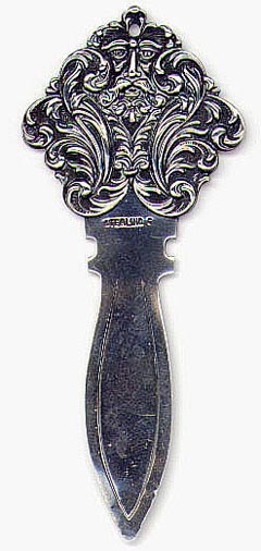 This bookmark is American made possibly by F.S. Gilbert. It is marked Sterling and some hallmark which is not clear but it looks like the letter G. It is a picture of a gargoyle or an old man with a lot of art nouveau designs around his head. Date is 1900 - 1920.